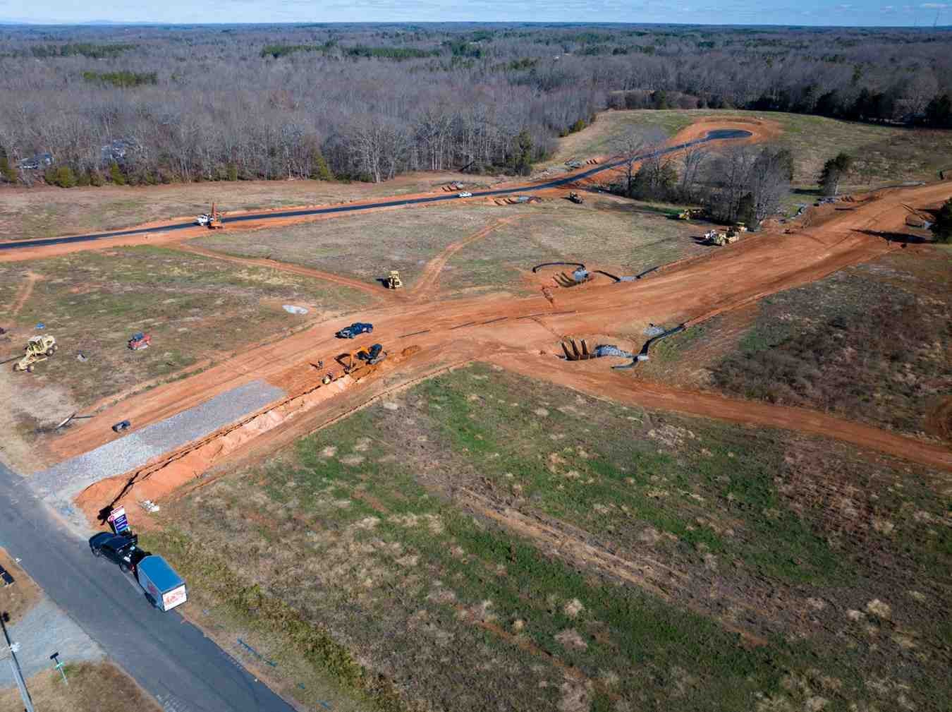 Aerial view of a bare rural landscape with construction ongoing for multiple roads, including a cul-de-sac.